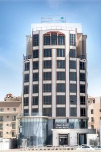 a tall building with a sign on the front of it at Aswar Boutique Hotel in Al Khobar