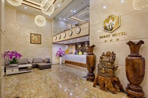 a lobby with a merry relief sign on the wall at Merry Hotel in Da Nang
