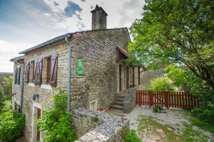 an old stone house with a red fence at Chez annie et jean michel Bagatelle chambres d hôtes in Châteauneuf