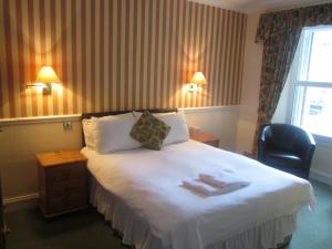 a hotel room with a bed with towels on it at Elder York Guest House in Edinburgh