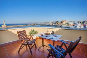 a table and chairs on a balcony with a view at Casa Leone Hotel in Chania