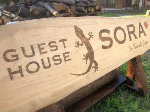 a sign for a guest house with a lizard on it at Guesthouse SORA in Minamiizu