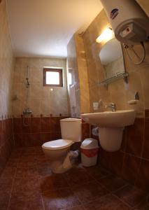 a bathroom with a toilet and a sink at Aurora Guest House in Nesebar +33 photos