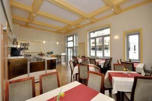 a restaurant with tables and chairs and a bar at Hotel Bova in Frankfurt/Main