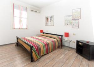 a bedroom with a bed and a tv in it at Lignano Luxury Villa***** in Lignano Sabbiadoro
