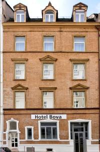 un gran edificio de ladrillo con un cartel de tazón de hotel en Hotel Bova, en Frankfurt