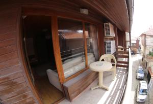 a small building with a table and a chair in it at Aurora Guest House in Nesebar