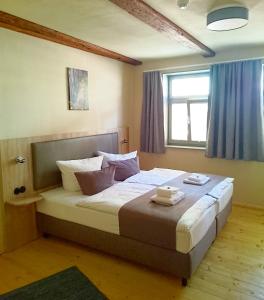 a bedroom with a large bed with pillows on it at Hotel garni Tilia in Quedlinburg