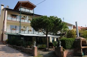 a building with a tree in front of it at Pension Bergel in Sankt Martin