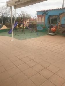 a park with a playground with a slide at Hostal Kavanna in San Pedro de Mérida