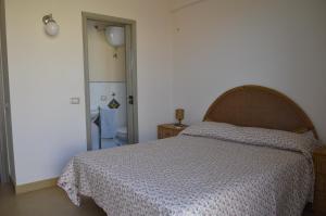 A bed or beds in a room at residence scala dei turchi