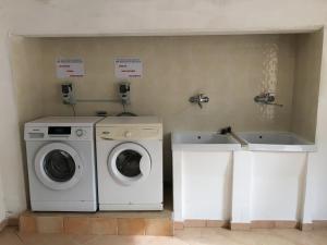 a laundry room with a washing machine and a sink at Villa delle Sirene in Ascea
