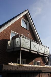 einen Balkon an der Seite eines Backsteingebäudes in der Unterkunft Haus Nordland in Langeoog