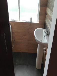 a bathroom with a sink and a window at Rahangala edge in Ohiya