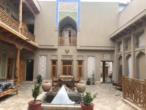 a courtyard with a fountain in the middle of a building at As-Salam Boutique Hotel in Bukhara