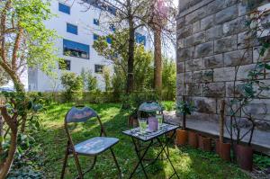 two chairs and a table in a garden at Apartment Hello Love in Split