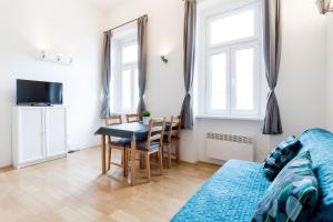 a living room with a table and a dining room at Flexible SelfCheckIns 13 & 14 - Le Petit & Le Grand Zagreb - Centre - New - Apartments Repinc in Zagreb