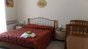 a bedroom with a red bed with a flower on it at Mare And City House in Manfredonia