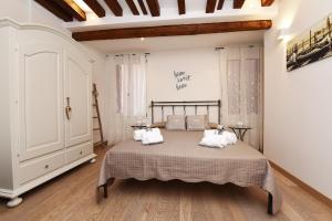 a bedroom with a bed with two pillows on it at homesweethome venice in Venice