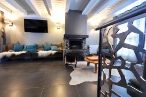 a living room with a couch and a fireplace at Au Selaou 34 in Val Thorens