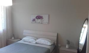 a bedroom with a bed with two pillows on it at B&B la Palma in Ruvo di Puglia