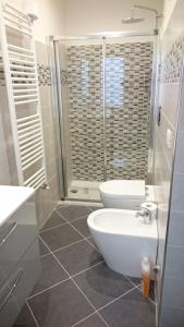 a bathroom with a toilet and a sink and a shower at Il Piccolo Loft della Vela in Savona +65 photos