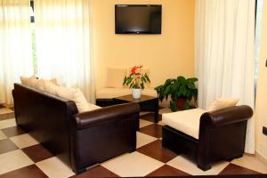 a living room with two chairs and a tv at Sweet Home B&B in San Ferdinando