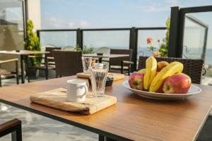 a wooden table with a plate of fruit on it at Artika Hotel in Istanbul
