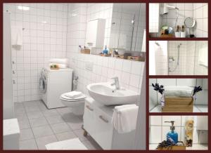 een witte badkamer met een wastafel en een toilet bij Panorama-Übernachtungen in Biberach-Ummendorf +24 foto's