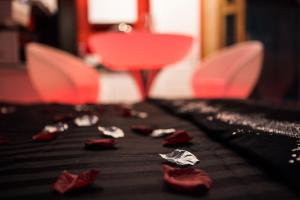 a table with red chairs and pieces of paper on it at Suite Glamour & Spa in Dijon