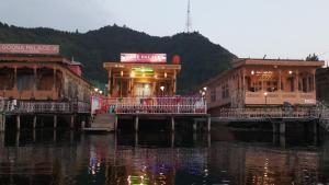 a group of buildings next to a body of water at Lake Palace Group Of House Boats in Srinagar