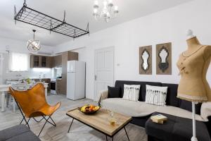 a living room with a couch and a table at EvaEle Luxury Apartments in Kissamos