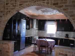 an archway in a kitchen with a refrigerator and a table at Villa Erasmia in Dhékarkhon +38 photos