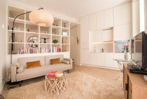 a living room with a couch and a table at Lisbon Rouge Apartment in the Lisbon Heart in Lisbon