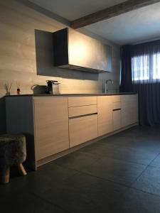 a kitchen with wooden cabinets and a sink at Charly Studio In Gstaad in Gstaad