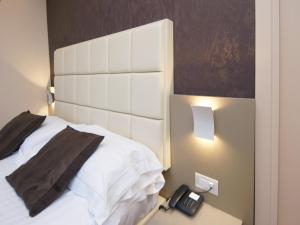 Un ou plusieurs lits dans un hébergement de l'établissement Hotel Dori