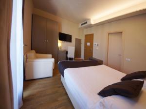 Un ou plusieurs lits dans un hébergement de l'établissement Hotel Dori