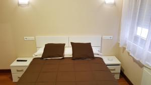Hostal Arenal客房内的一张或多张床位