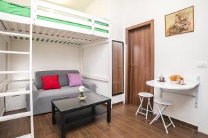 a small room with a bunk bed and a table at Midtown Center Apartments in Zadar