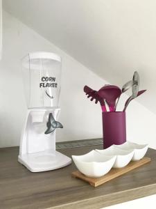 a kitchen counter with a white food processor and a vase at Zollernalb-Apartment in Albstadt