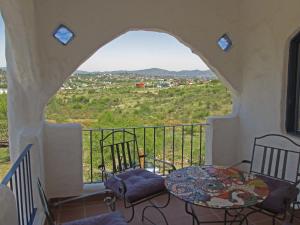 a balcony with a table and chairs and a view at El Faro de Carpier - ApartHotel & Restaurante Bar Cafetería in Tanti