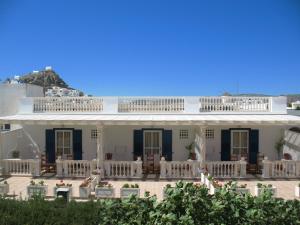 a white house with a balcony on top of it at Parthenon in Ios Chora