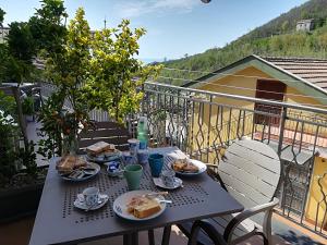 a table with plates of food on a balcony at Il Covo delle Civette in Vietri sul Mare