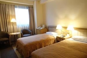 Postel nebo postele na pokoji v ubytování Urayasu Beaufort Hotel