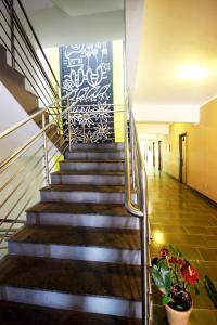 a staircase in a building with a painting on the wall at Cris Hotel in Florianópolis