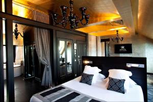 a bedroom with a bed with white sheets and pillows at Maison Albar- Le Champs-Elysées in Paris