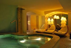 a large bathroom with a tub in a room at Grand Hotel Savoia in Genoa