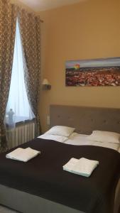 Postel nebo postele na pokoji v ubytování Taurus Apartments Vilnius