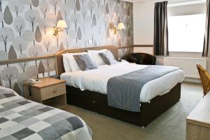 Postel nebo postele na pokoji v ubytování Millfields Hotel