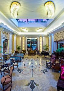 a lobby with chairs and tables in a building at Grand Hotel Savoia in Genoa